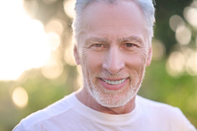 A picture of a gray-haired man looking confident