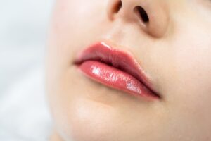 Female lips after permanent makeup lip blushing procedure