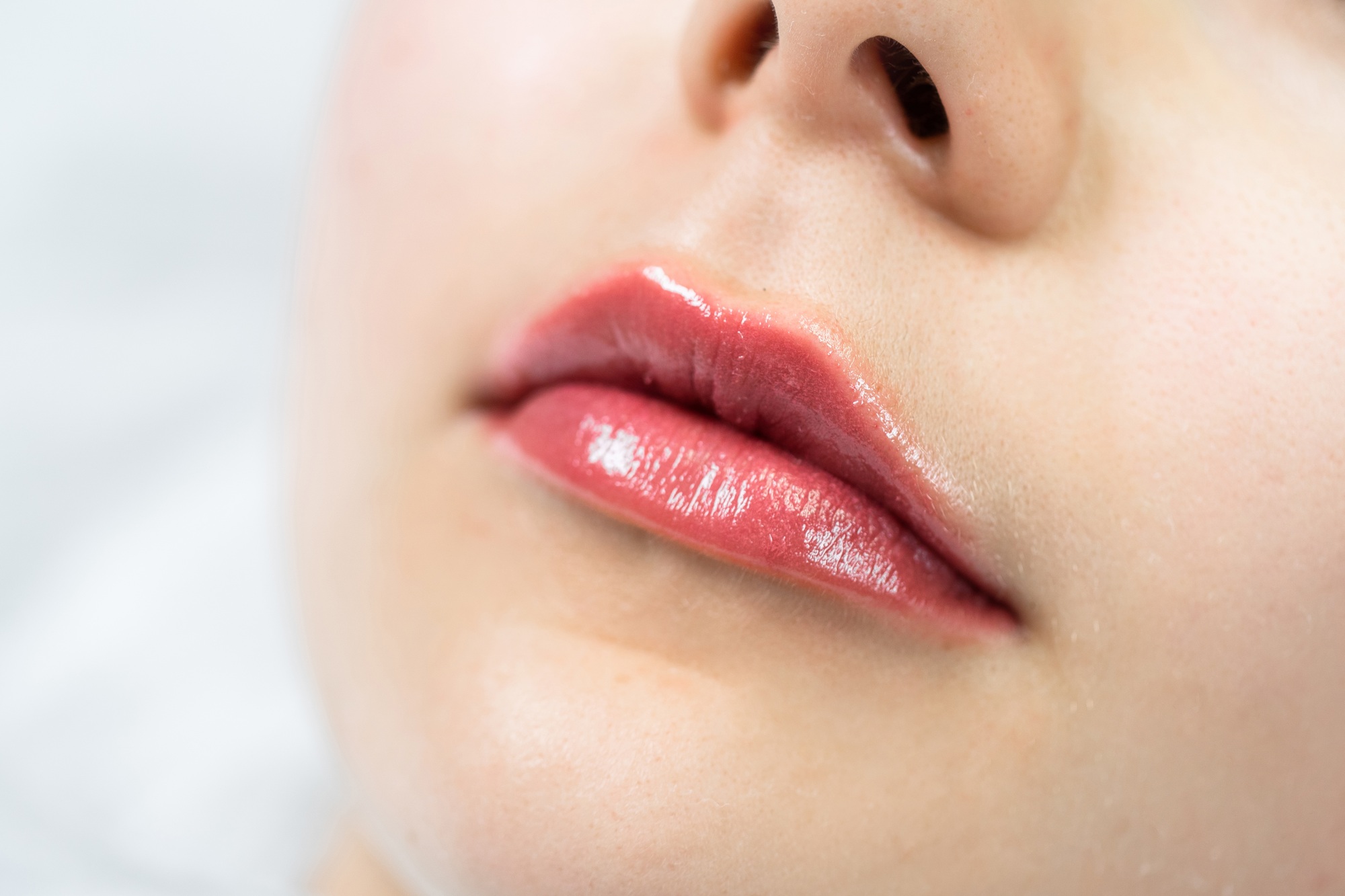Female lips after permanent makeup lip blushing procedure